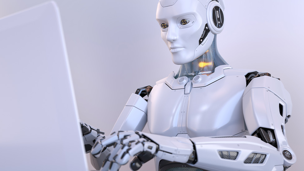 A humanoid robot working on a computer.